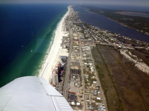 Scenic Flight over the beach in Gulf Shores, AL before maneuver training over the bay.   